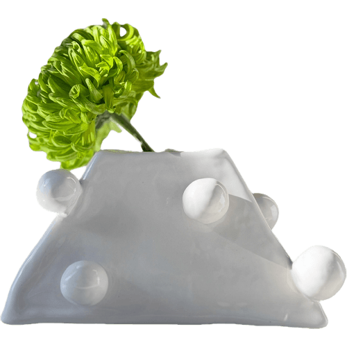 White ceramic blob vase with green flower